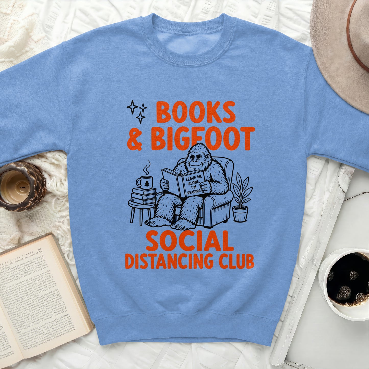 Light blue sweatshirt with a graphic of Bigfoot reading and text.