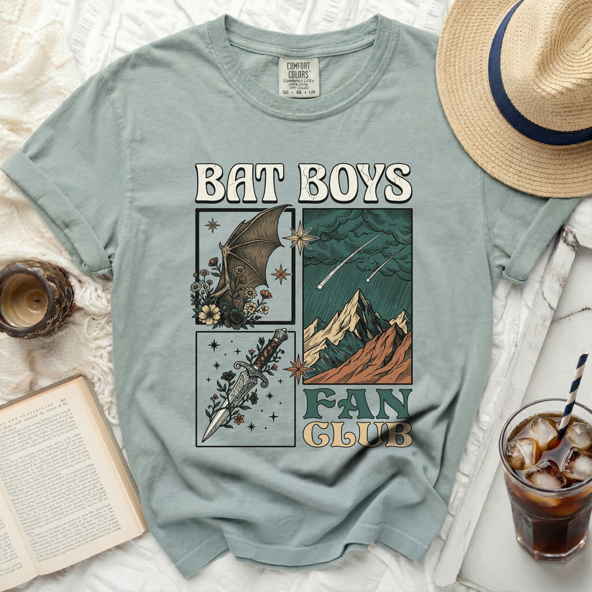 Light blue t-shirt with "Bat Boys Fan Club" graphic featuring a bat, dagger, and mountains.