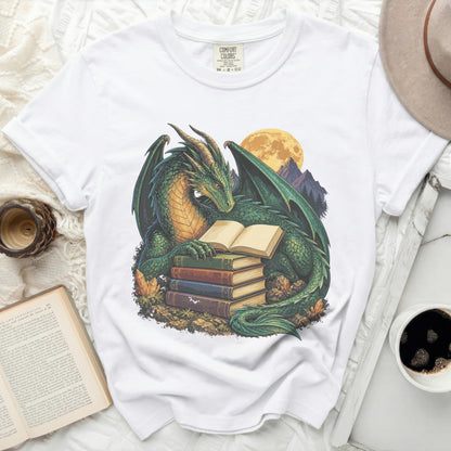 Green dragon reading books against a moonlit mountain backdrop.
