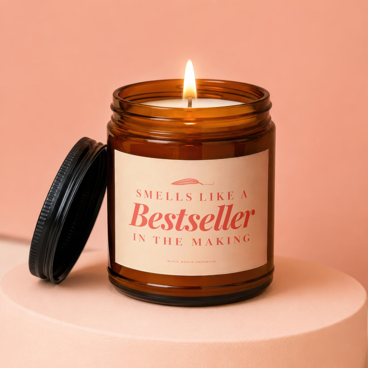 Amber jar candle with lit wick and lid off. Label reads "Smells like a Bestseller in the making".