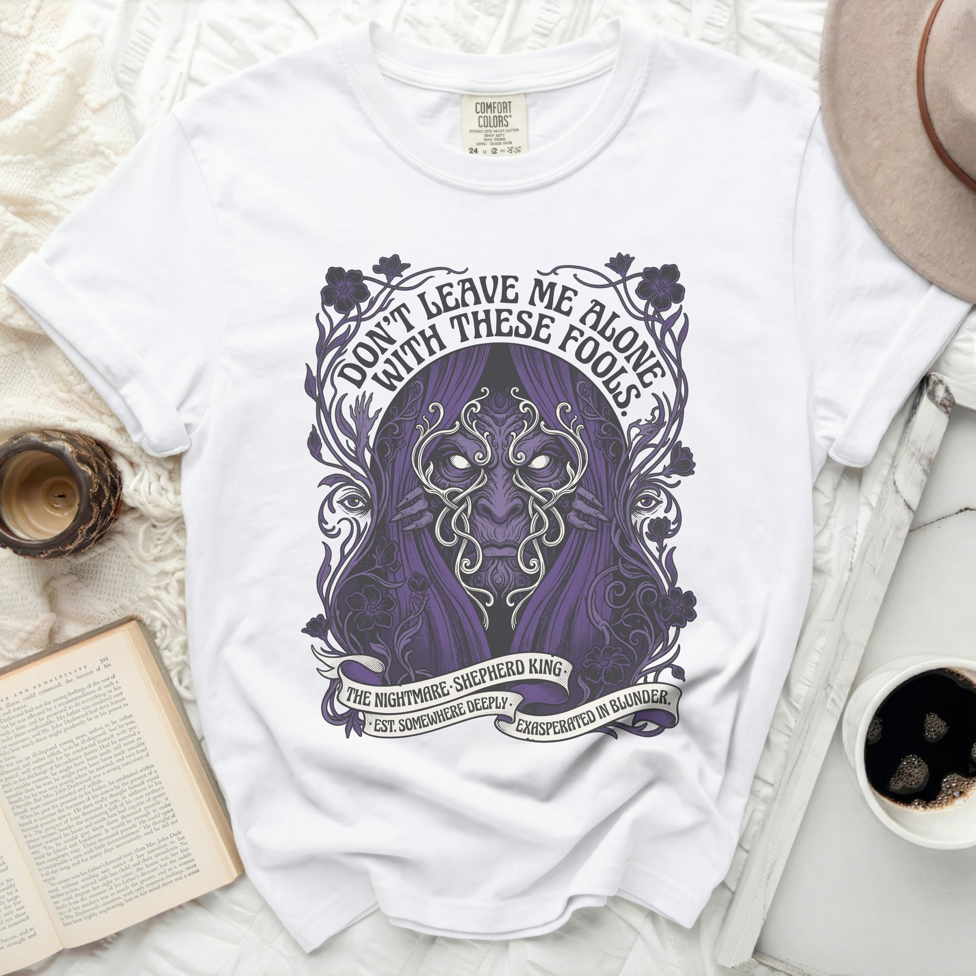 White t-shirt with purple graphic art and text.