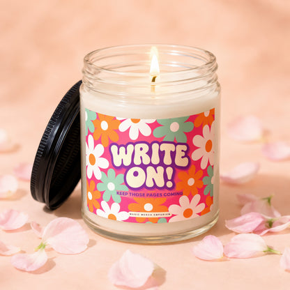 Glass candle with "WRITE ON! KEEP THOSE PAGES COMING" text and floral design.