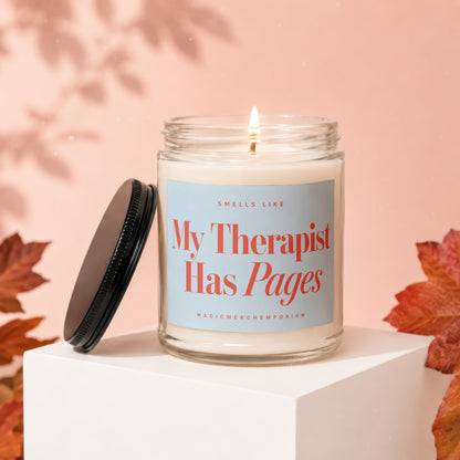 Scented candle with "My Therapist Has Pages" text on a pale blue label.