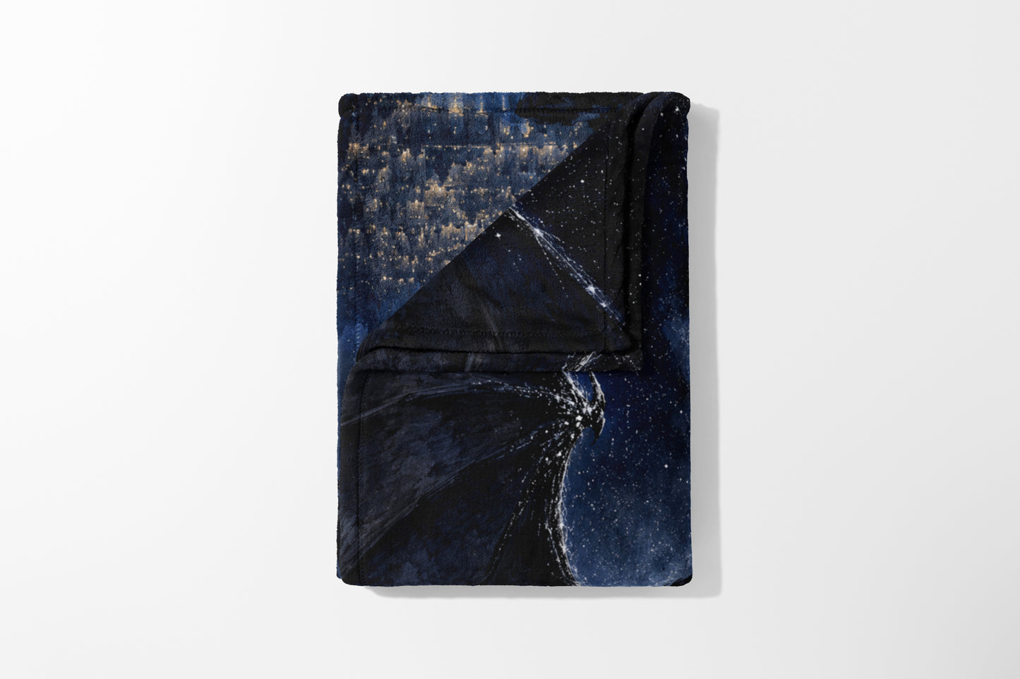 Folded blanket with a dark blue and gold starry night sky pattern.