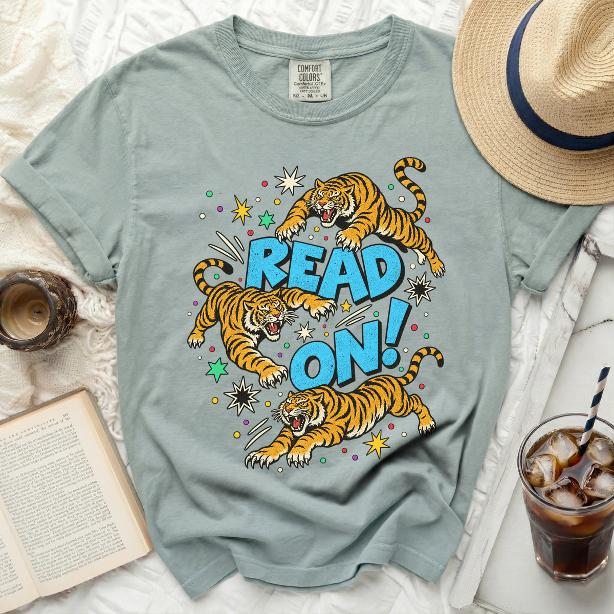 Light blue t-shirt with graphic of three tigers and text "READ ON!".