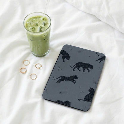 Grey case with black tiger pattern and constellations, beside iced matcha latte.