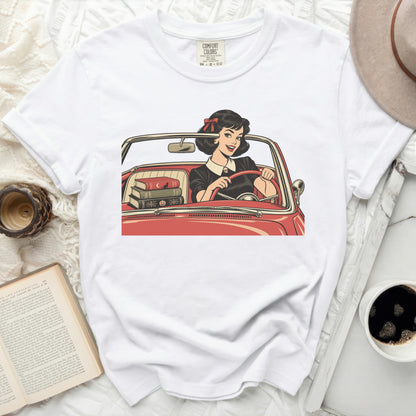 White t-shirt with vintage comic art of a woman driving a red convertible.