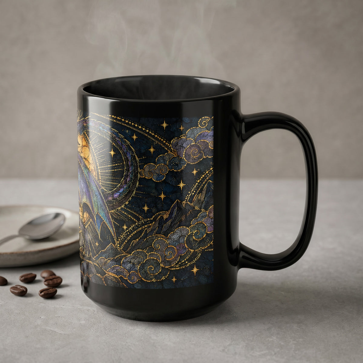 A black ceramic mug features a celestial stained glass dragon design, sitting on a grey surface with scattered coffee beans.