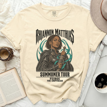 Cream t-shirt with Rhiannon Matthias "Summoner Tour" graphic.