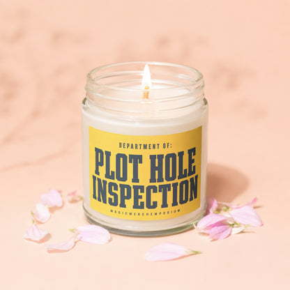 Glass jar candle with a yellow label reading "DEPARTMENT OF: PLOT HOLE INSPECTION".