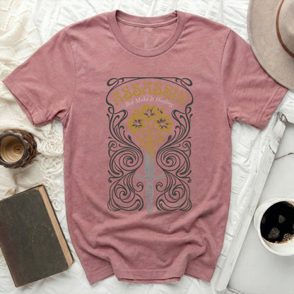 T-shirt with "Assassin But Make It Healing" text and floral sword design.