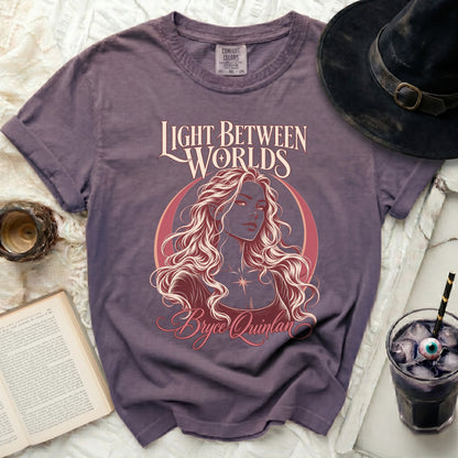Purple t-shirt with "Light Between Worlds Bryce Quinlan" and character art.