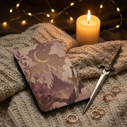 Book cover with celestial mountain and sword illustration, with candle and rings.