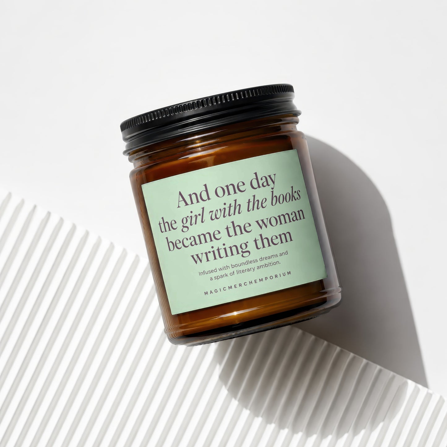 Amber jar candle with light green label featuring a quote and text.