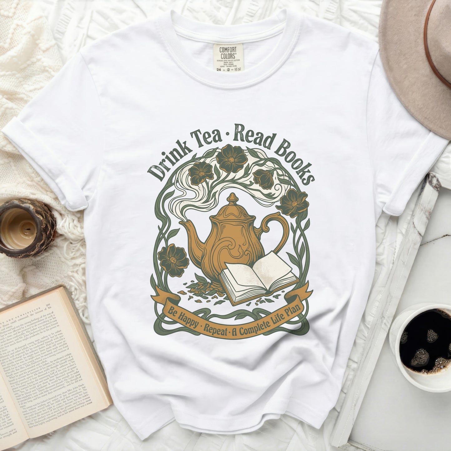 White t-shirt with "Drink Tea. Read Books" graphic and floral teapot.