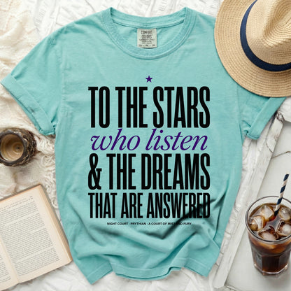 Teal t-shirt with black and purple text "To the Stars Who Listen & The Dreams That Are Answered".