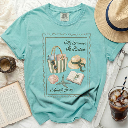 Teal t-shirt with "My Summer Is Booked" and Amalfi Coast graphic.