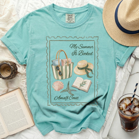 Teal t-shirt with "My Summer Is Booked" and Amalfi Coast graphic.