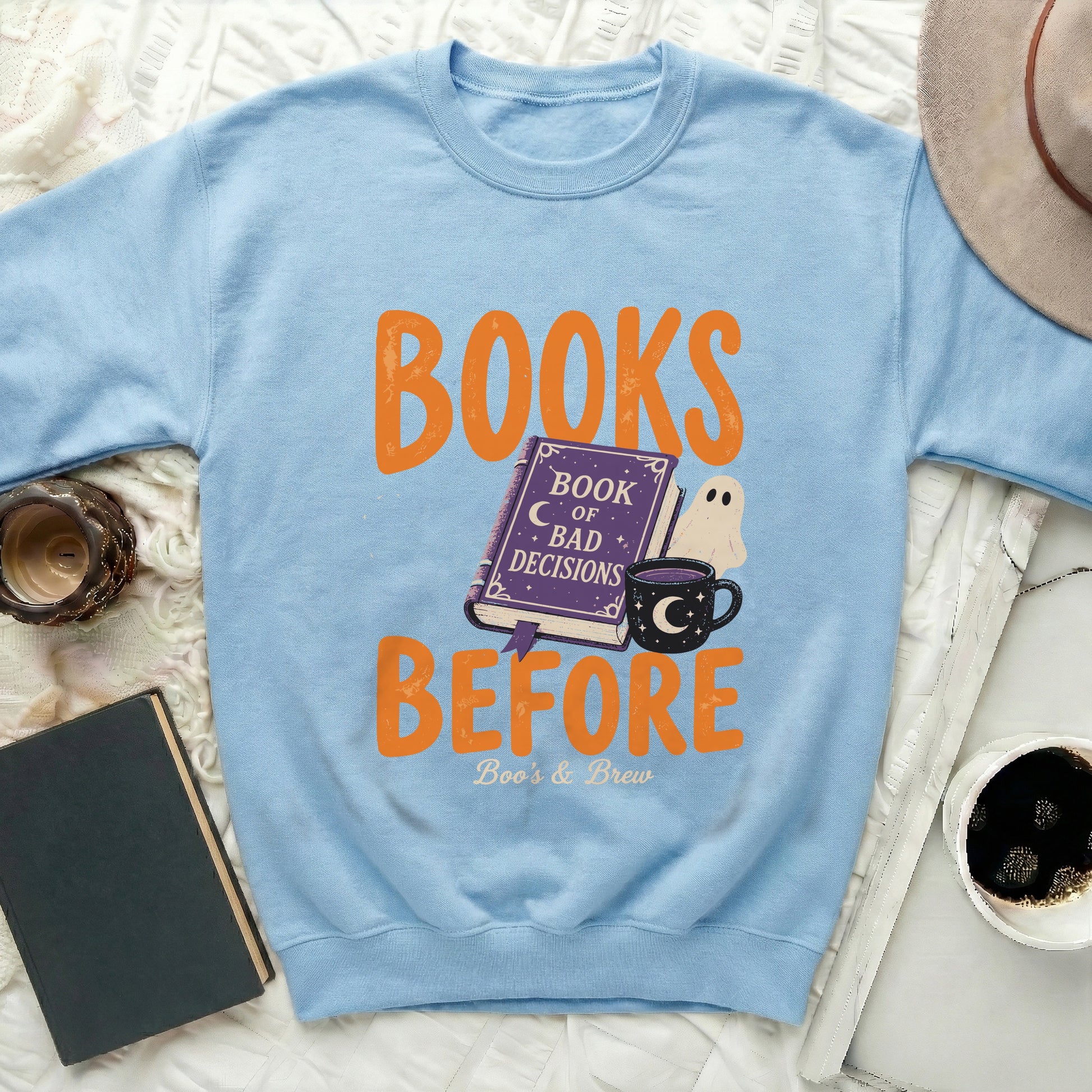 Light blue sweatshirt with "BOOKS BEFORE" and "Boo's & Brew" Halloween graphic.