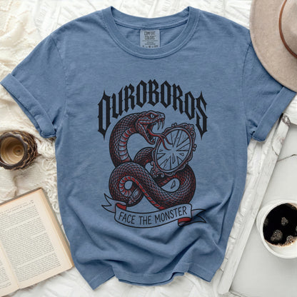 Blue t-shirt with Ouroboros snake and "Face the Monster" text graphic.