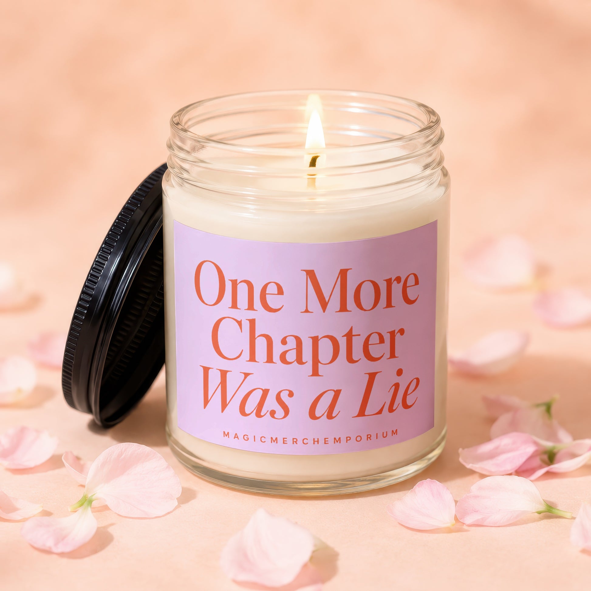 Candle with lid off, reads "One More Chapter Was a Lie" and "MagicMerchEmporium."