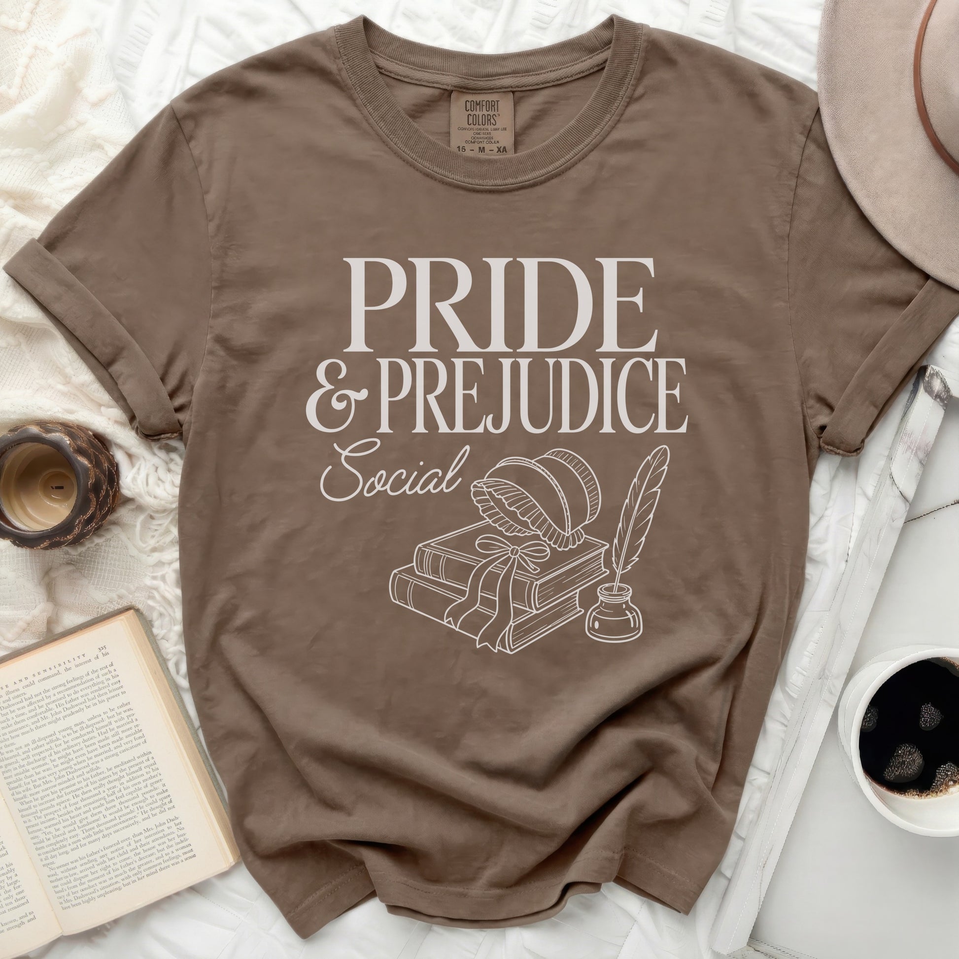 Brown t-shirt with "Pride & Prejudice Social" text and line art.