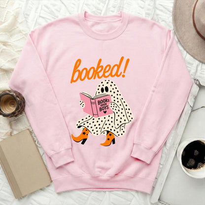 Pink sweatshirt with ghost graphic reading "booked!" and "books over boys".