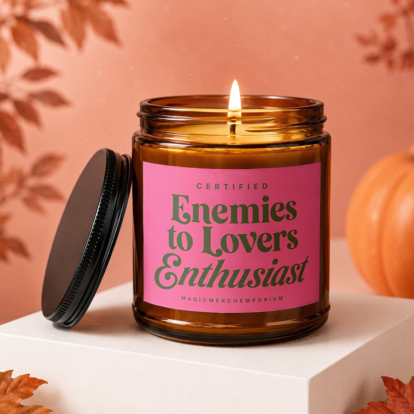Amber jar candle with pink label saying "Certified Enemies to Lovers Enthusiast".
