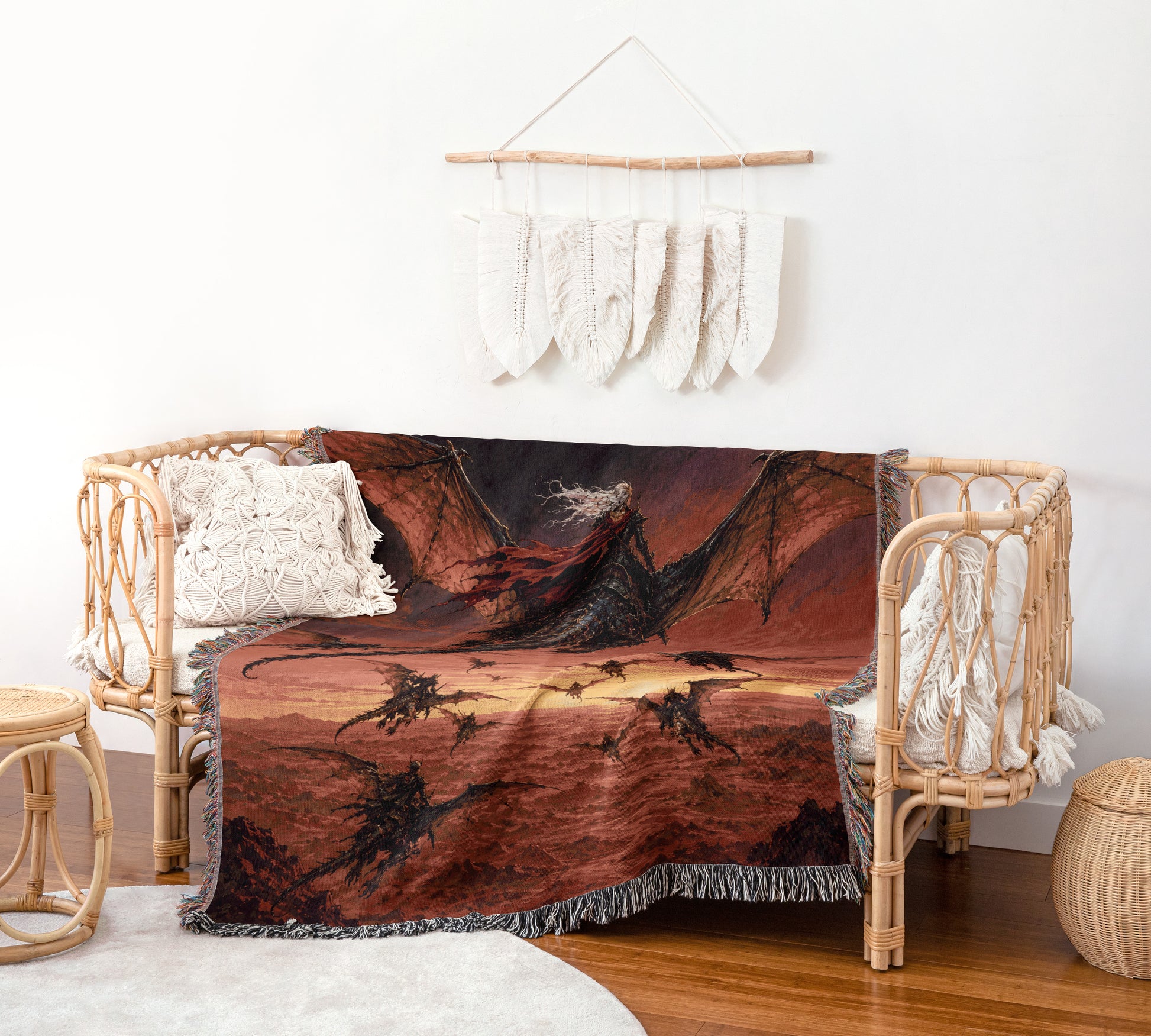 a cozy living room with a woven bench and a dragon-themed throw blanket draped over it. The blanket has a striking red and black dragon design, and it is hanging on a wall with white feathers. The room also includes a woven stool and a woven basket, adding to the rustic and comfortable atmosphere.