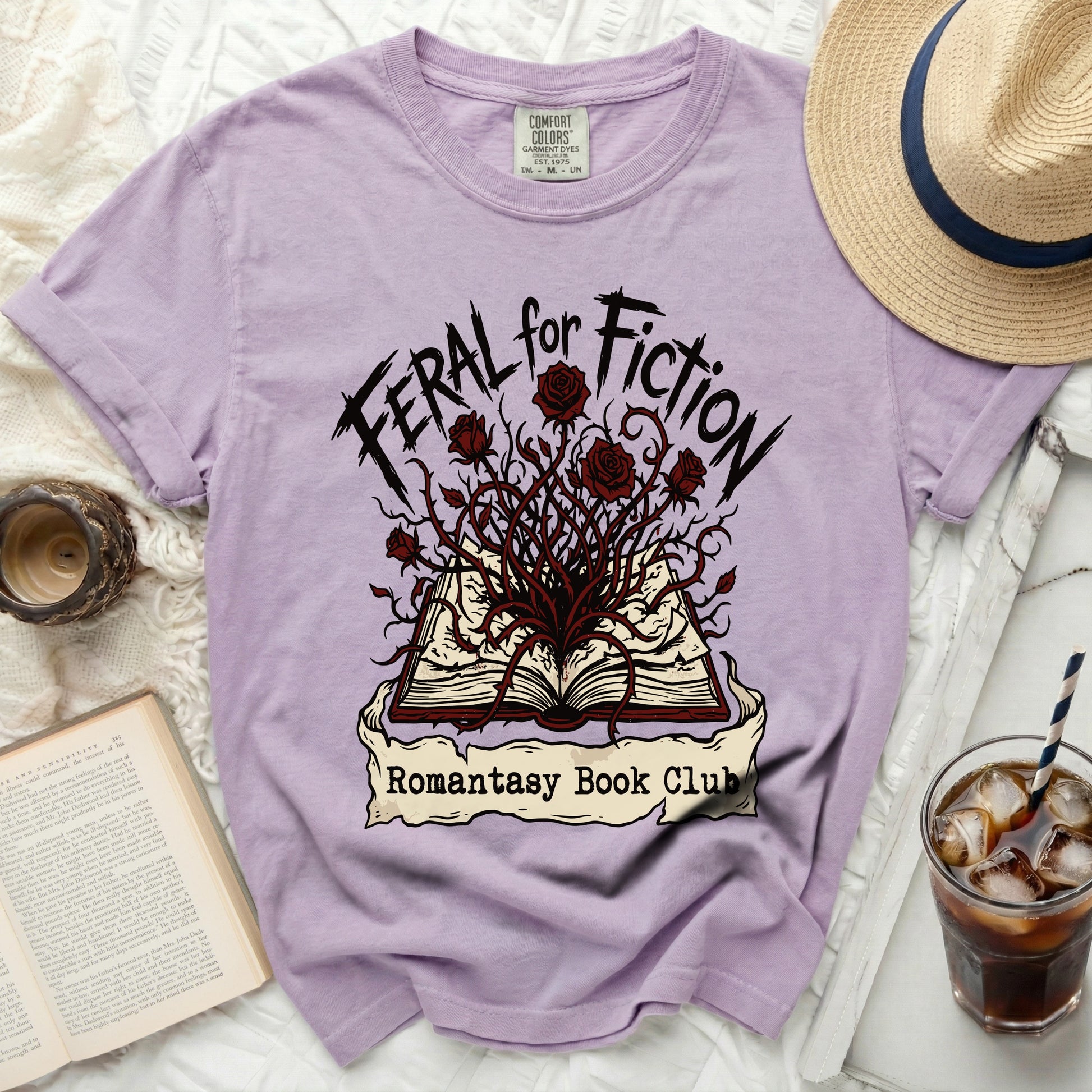 Purple t-shirt with "Feral for Fiction" and "Romantasy Book Club" text and graphics.