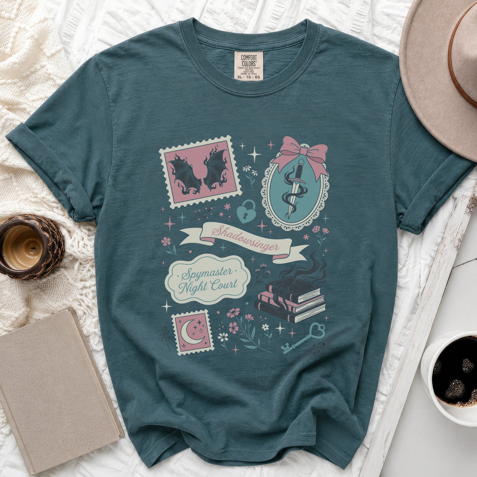 Teal t-shirt with "Shadowsinger Spymaster Night Court" graphic and book motifs.