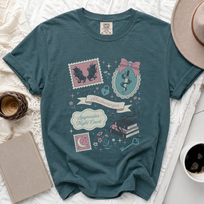 Teal t-shirt with "Shadowsinger Spymaster Night Court" graphic and book motifs.