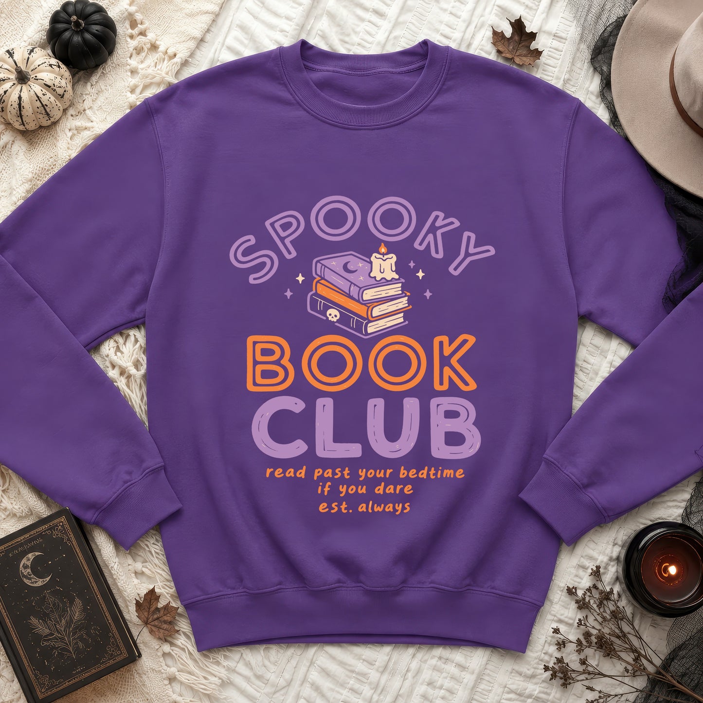 Purple sweatshirt with spooky book club graphic and reading quote.