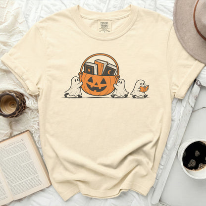 Cream t-shirt with cartoon ghosts carrying a pumpkin basket of books.