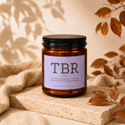 Brown apothecary jar candle labeled "TBR" with bookish definition.