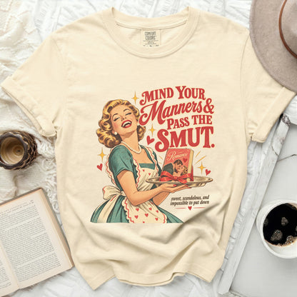 T-shirt with retro graphic: "Mind Your Manners & Pass The Smut" and romance book.