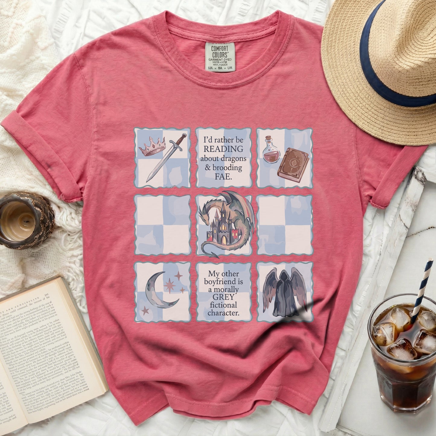 Pink t-shirt with "reading about dragons & brooding FAE" and "morally grey fictional character" text.
