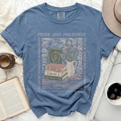 Blue t-shirt with Pride and Prejudice quote and book illustration.