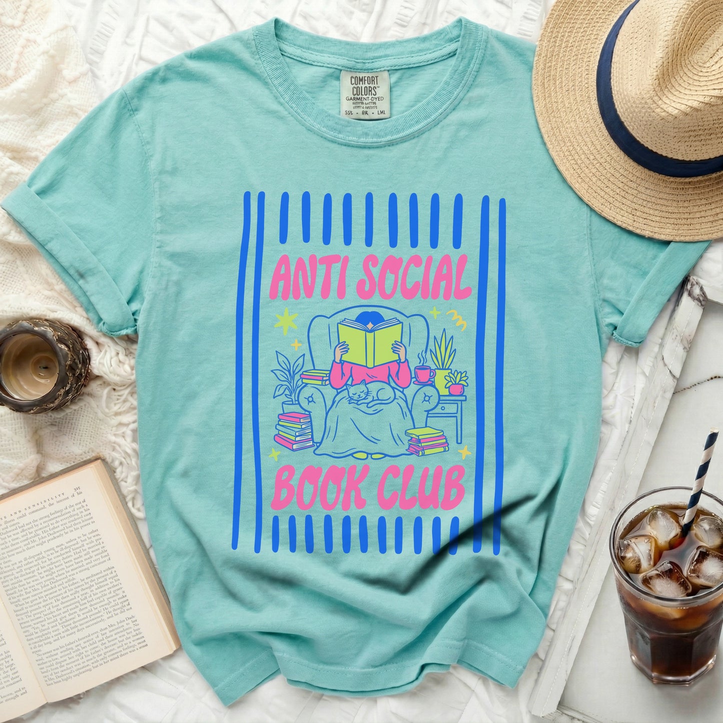 Teal t-shirt with "ANTI SOCIAL BOOK CLUB" text and illustrated reader.