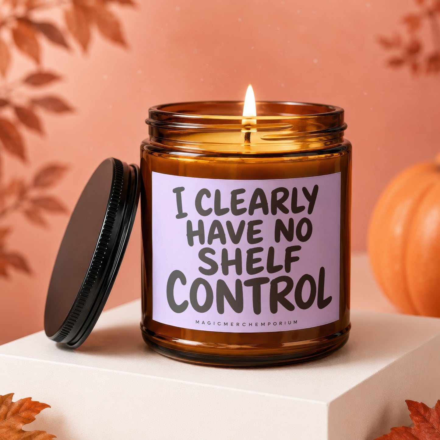 Amber candle with lid off, labeled "I CLEARLY HAVE NO SHELF CONTROL".