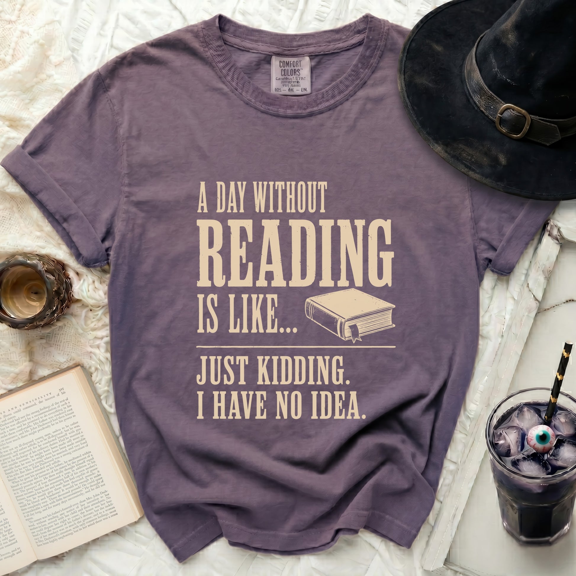 Purple t-shirt with "A day without reading is like... Just kidding. I have no idea." text.