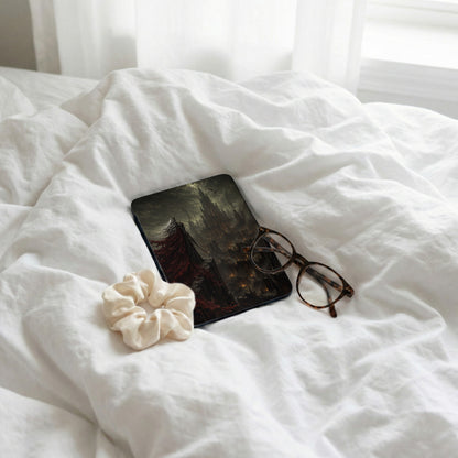 Dark fantasy castle artwork on a book cover with glasses and scrunchie.