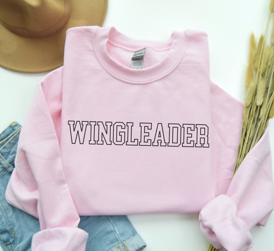 a pink sweater with the word wingleader printed on it