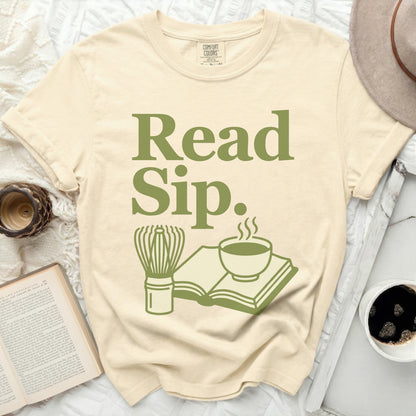 Cream t-shirt with "Read Sip." in green, featuring book and beverage icons.