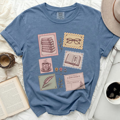 T-shirt with postage stamp designs featuring books and a teacup.