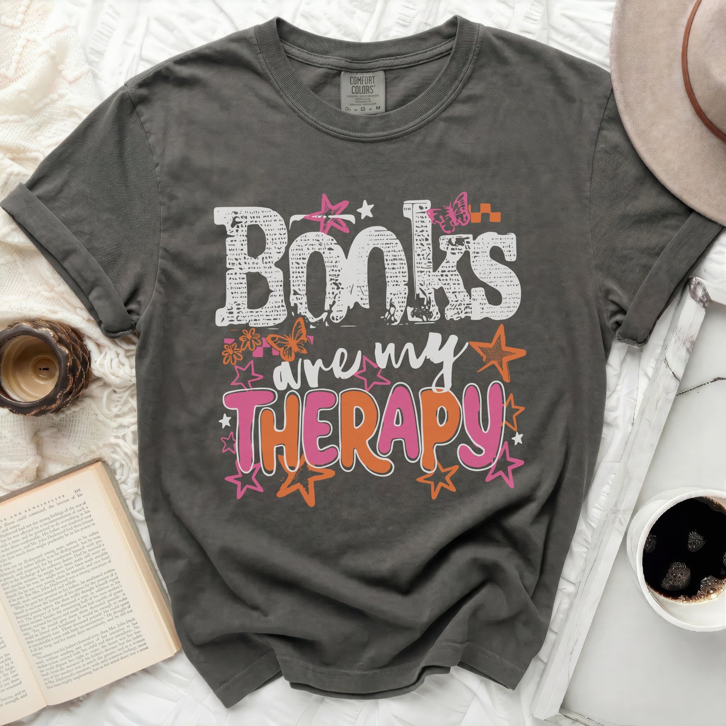 Gray t-shirt with the words "Books are my THERAPY" in colorful lettering.