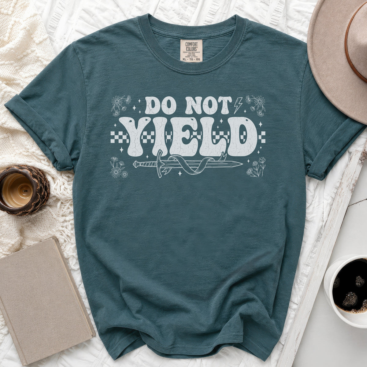 Teal t-shirt with "DO NOT YIELD" text, sword, and flowers.