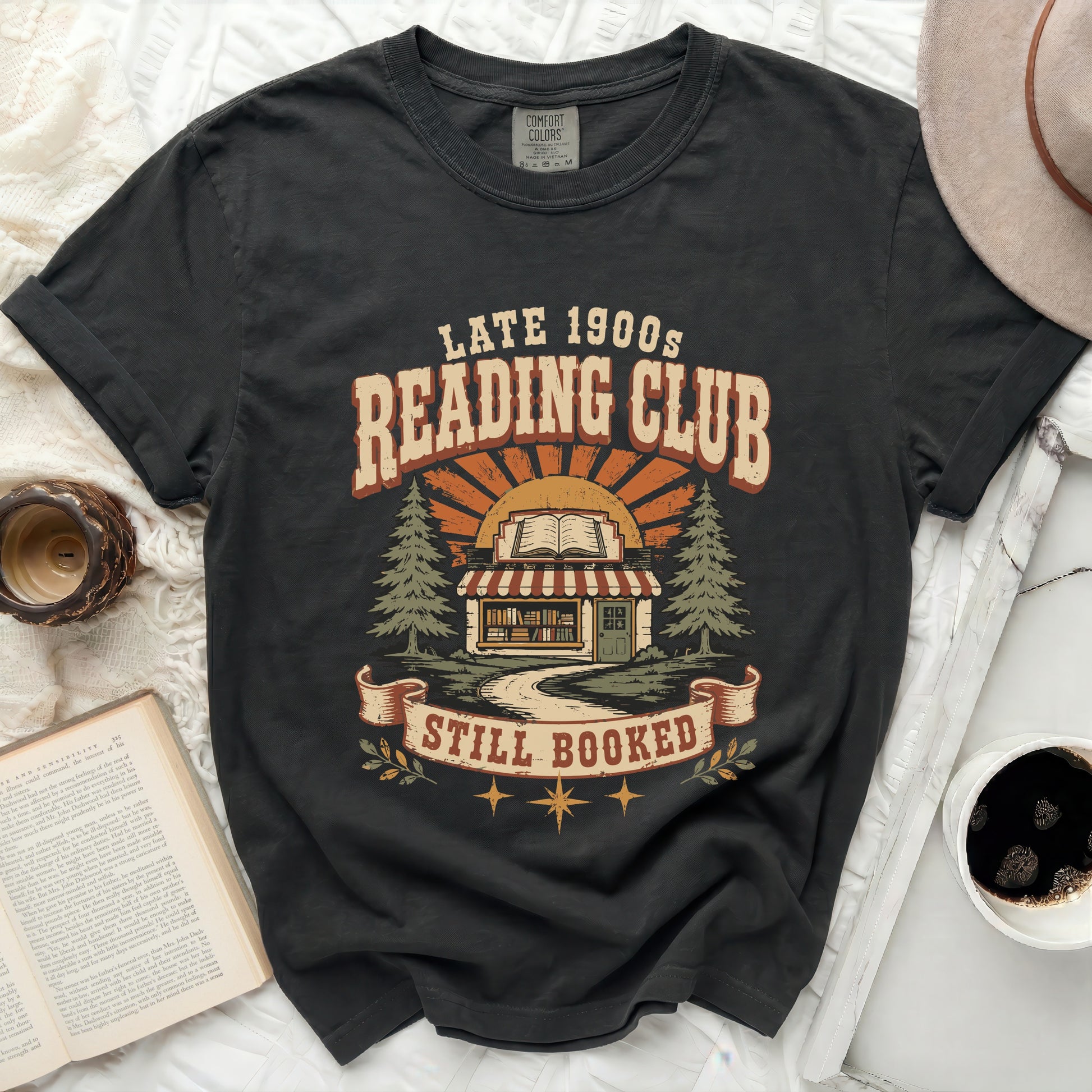 Comfort Colors black t-shirt with "Late 1900s Reading Club Still Booked" graphic.