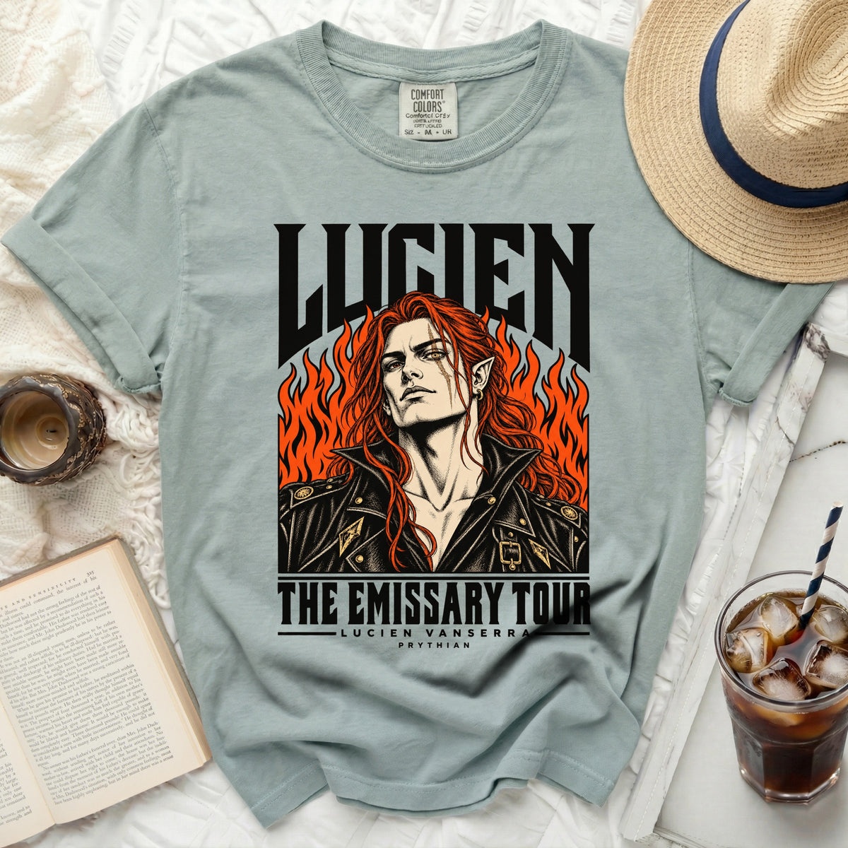 T-shirt featuring "LUCIEN THE EMISSARY TOUR" with an illustration of a character.