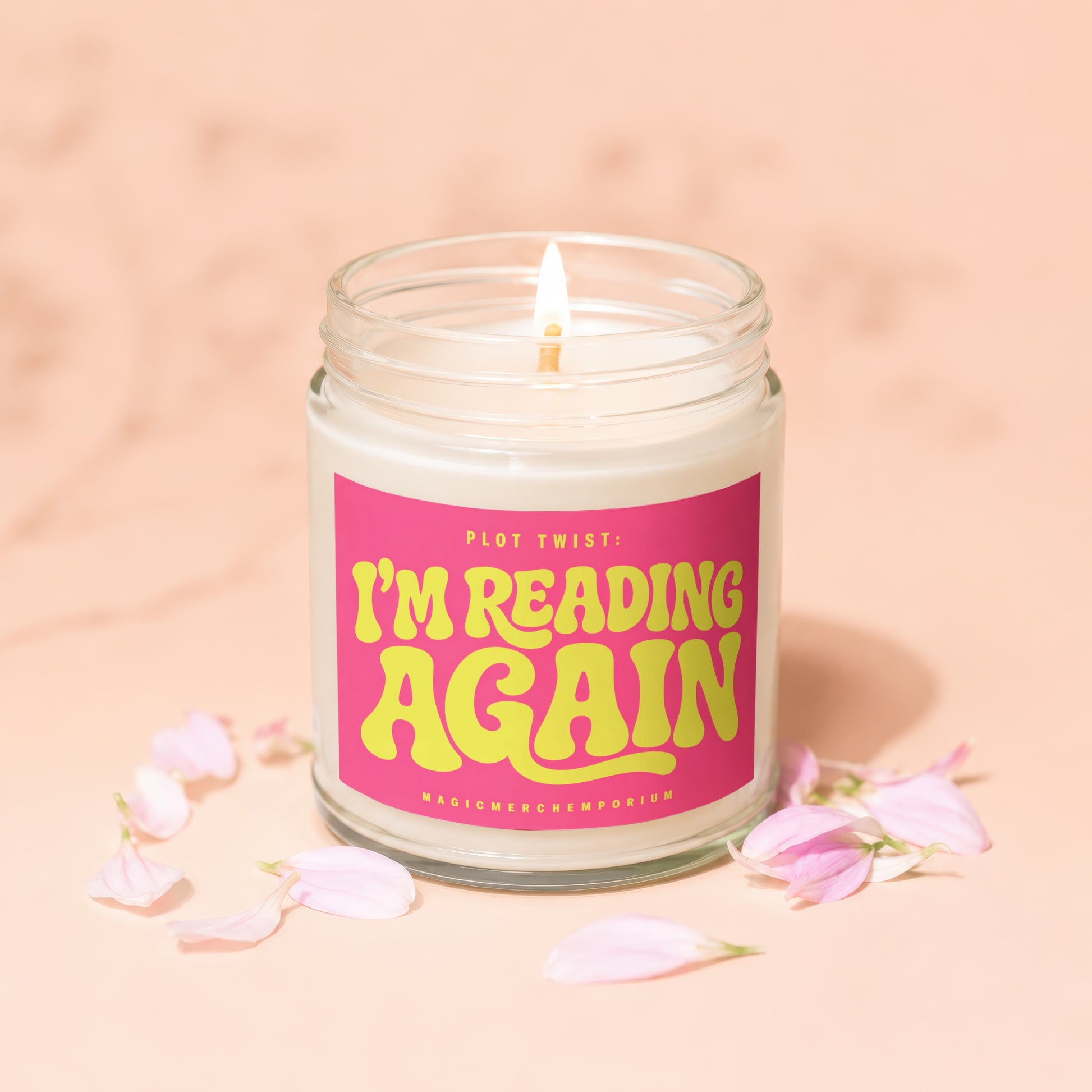 Candle with pink label reading "Plot Twist: I'm Reading Again".
